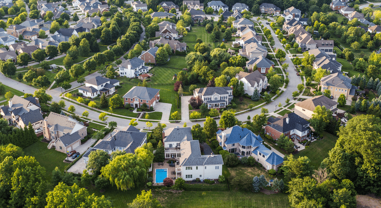 Couple reviewing positive housing market data with a real estate advisor
